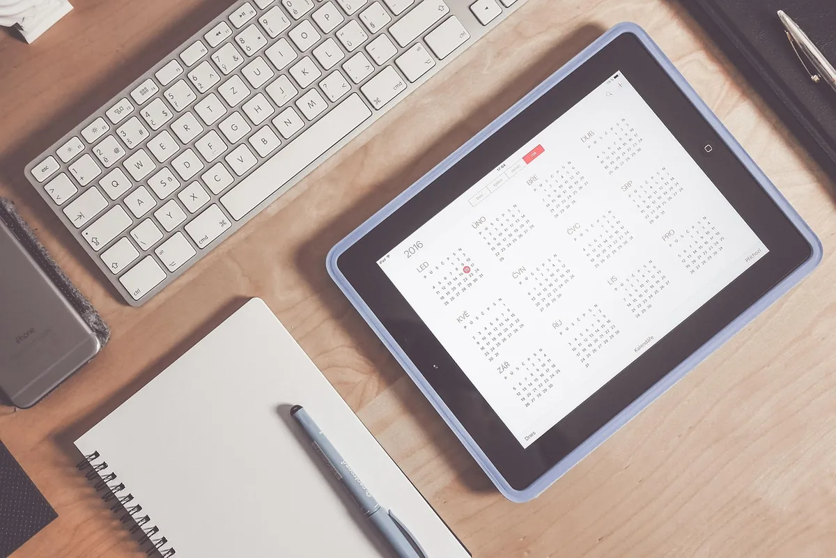 A desk calendar and pen for planning home maintenance