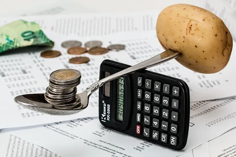 A calculator and coins for budgeting costs