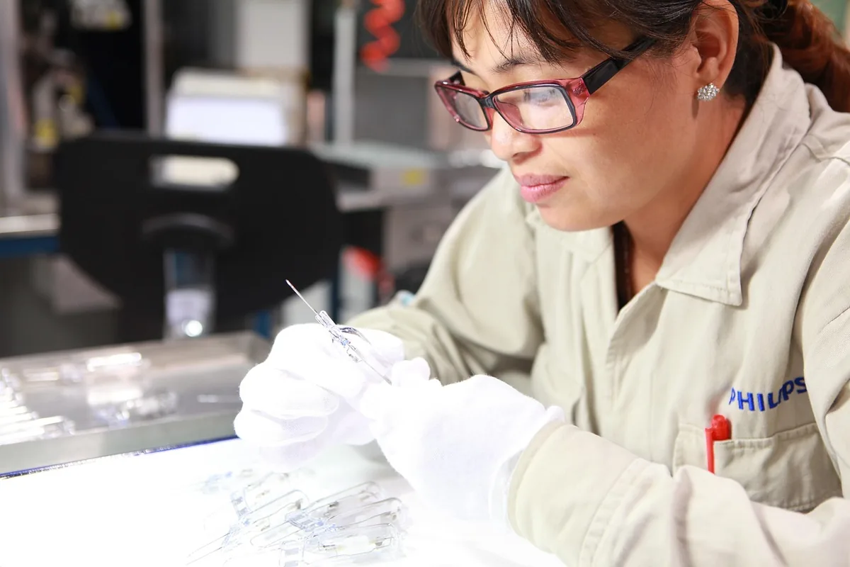 A technician in uniform inspecting at work