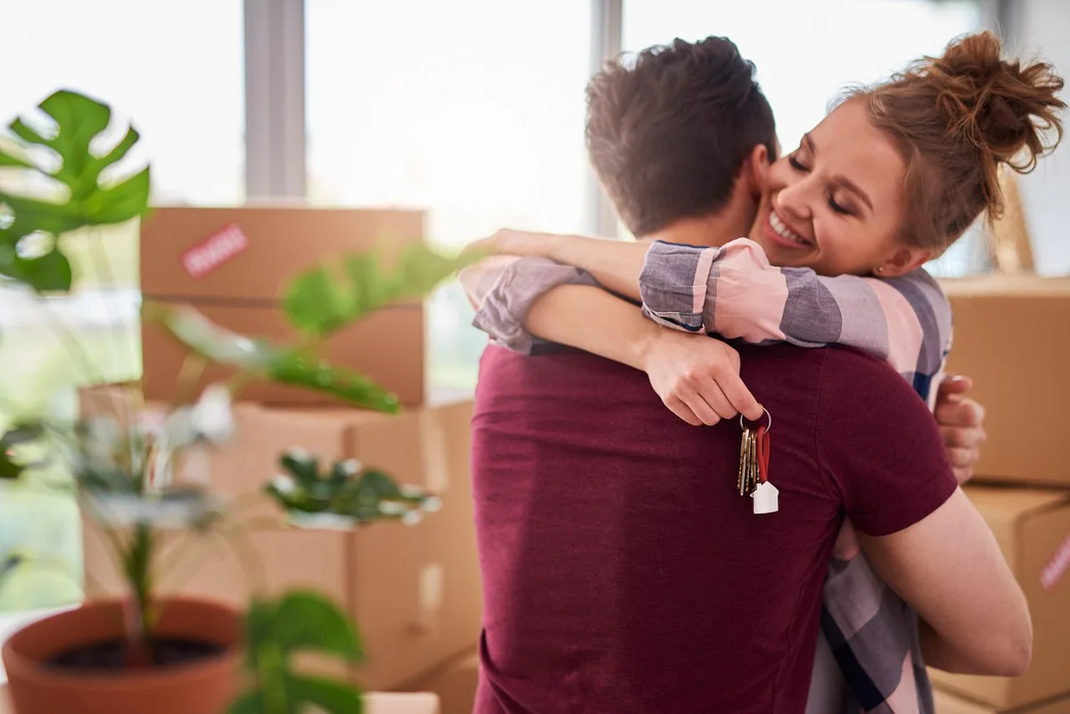 A couple unpacking moving boxes in a new home