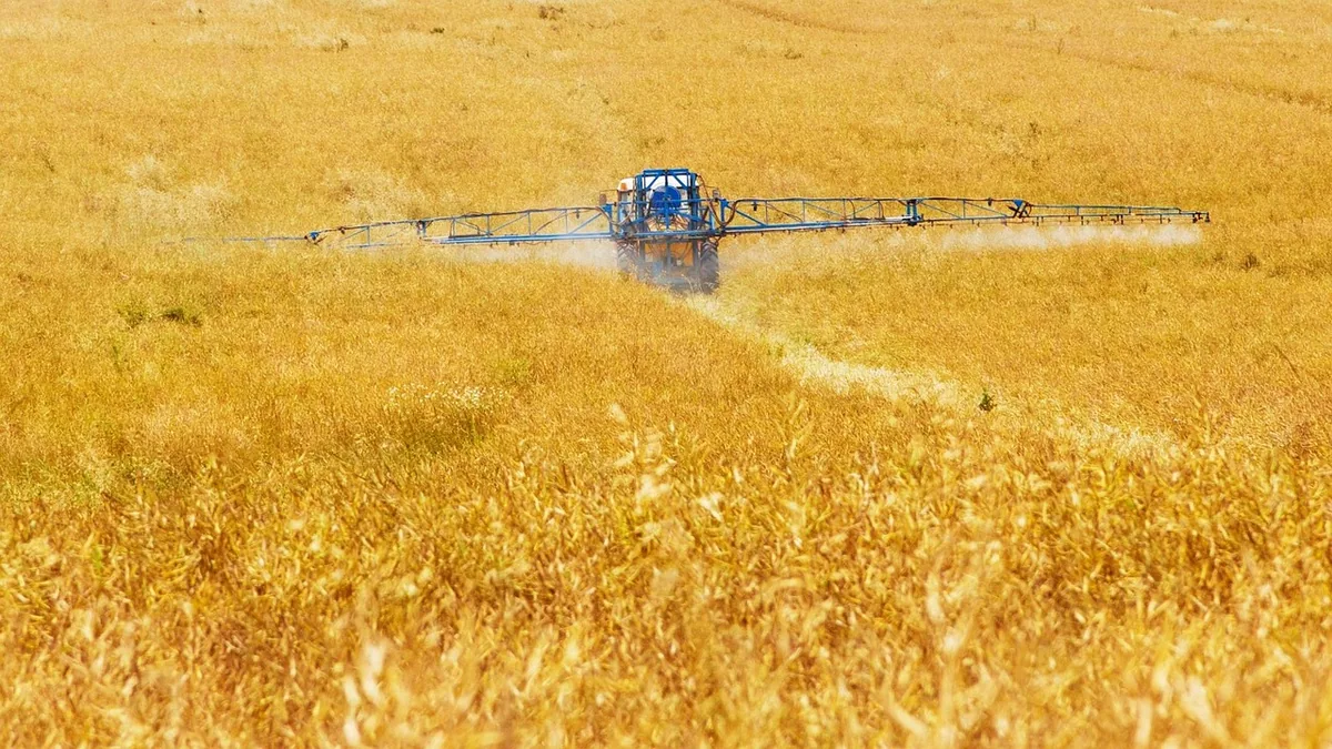 A vintage agricultural sprayer in a field