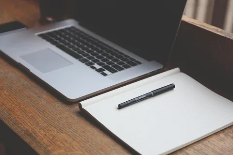 A home office desk with a laptop