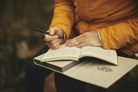 Hands reading and noting product details