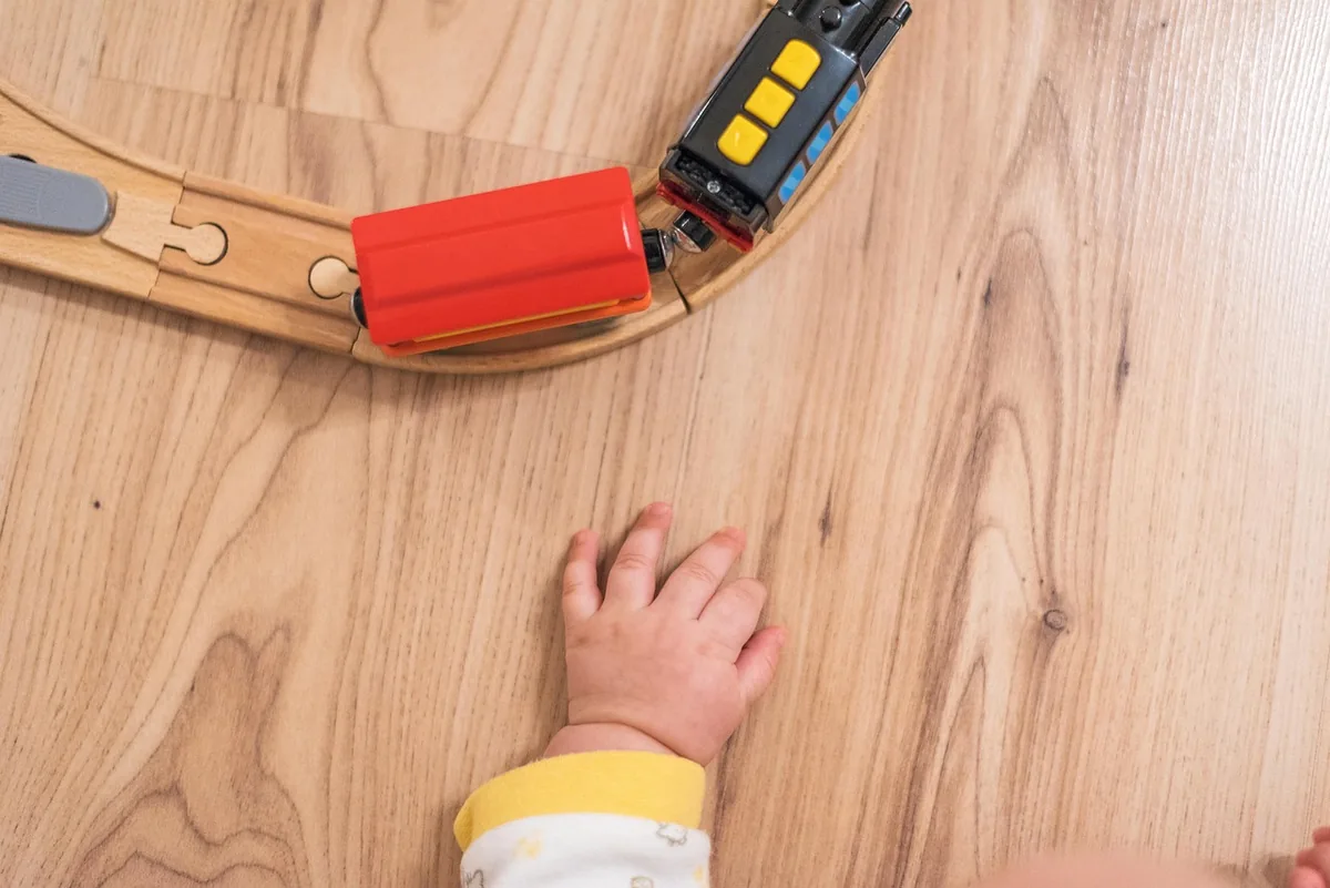 A baby crawling on a clean home floor